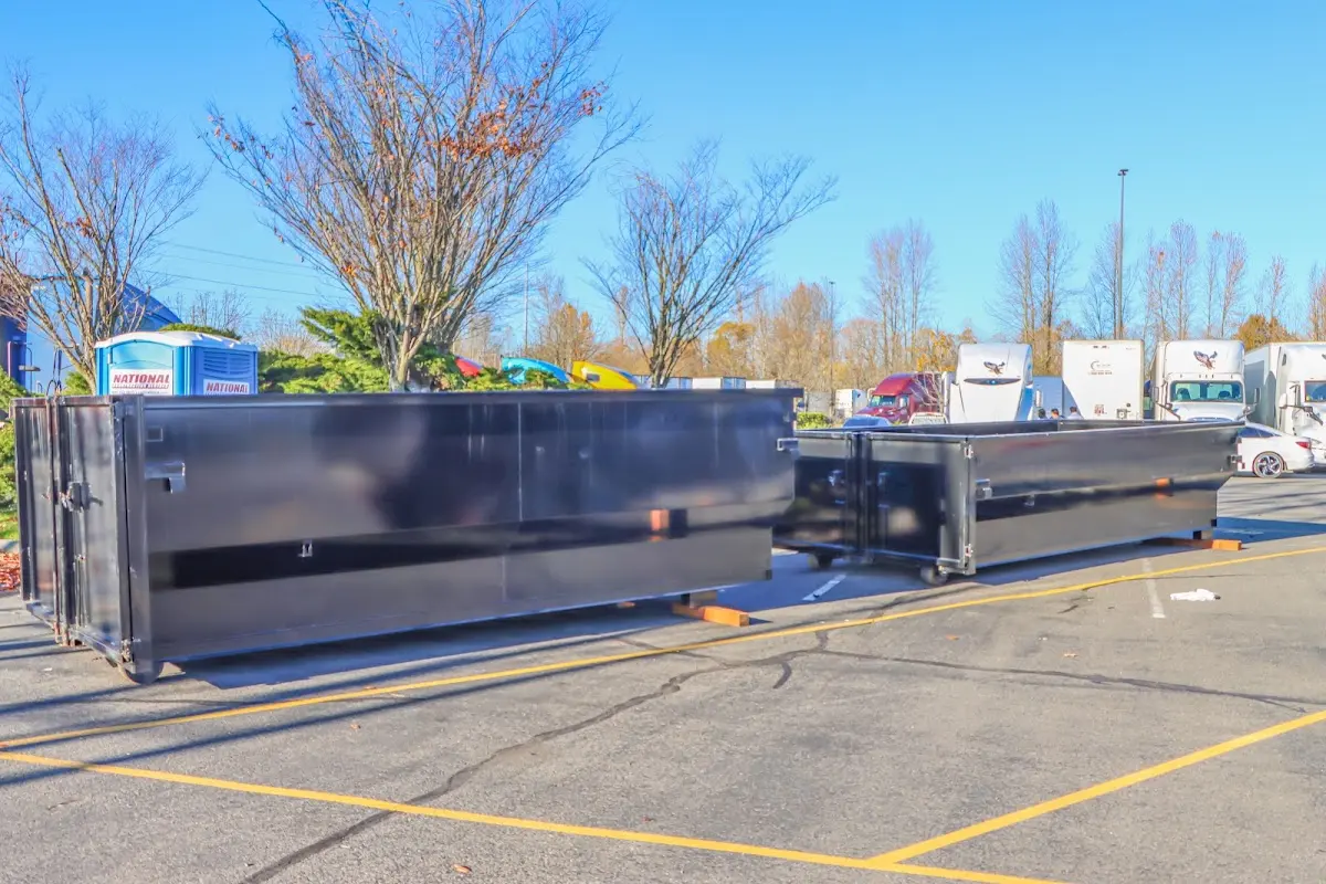 Professional dumpster rental service with roll-off container on residential driveway in North Potomac
